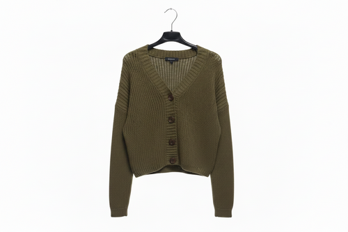 Green cardigan on a hanger against a white background