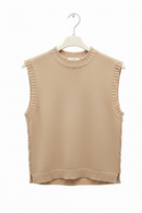 Beige sleeveless knitted top on a hanger against a white background
