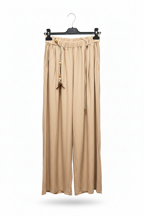Beige wide-leg pants hanging on a black hanger against a white background