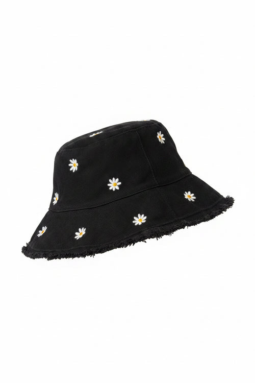 Black hat with white daisy flowers on a door