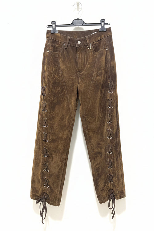 Brown corduroy pants with lace-up sides on a hanger against a white background