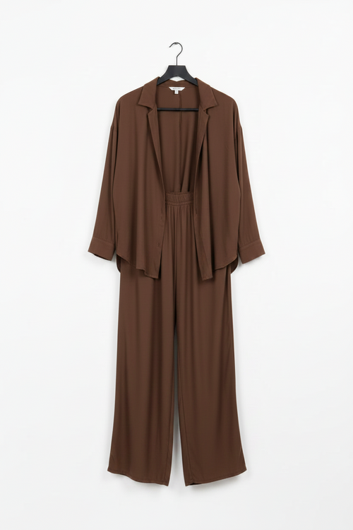 Brown jumpsuit on a hanger against a white background