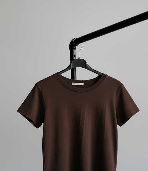 Brown t-shirt on a hanger against a gray background