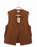 Brown vest on a hanger with a visible tag against a white background