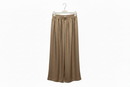 Brown wide-leg pants on a hanger against a white background