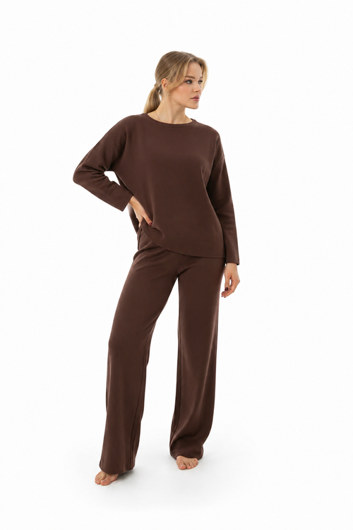 Model wearing KAMI chocolate brown knitwear set featuring a relaxed long-sleeve top and wide-leg knit pants on a white studio background.