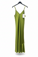 Green slip dress on a hanger with a visible tag against a white background
