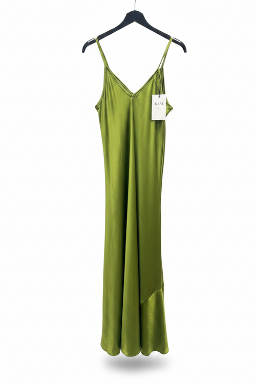 Green slip dress on a hanger with a visible tag against a white background