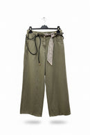 Green wide-leg pants with a patterned belt on a hanger against a white background