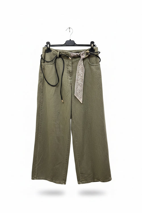 Green wide-leg pants with a patterned belt on a hanger against a white background