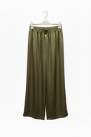 Green wide-leg pants on a hanger against a white background
