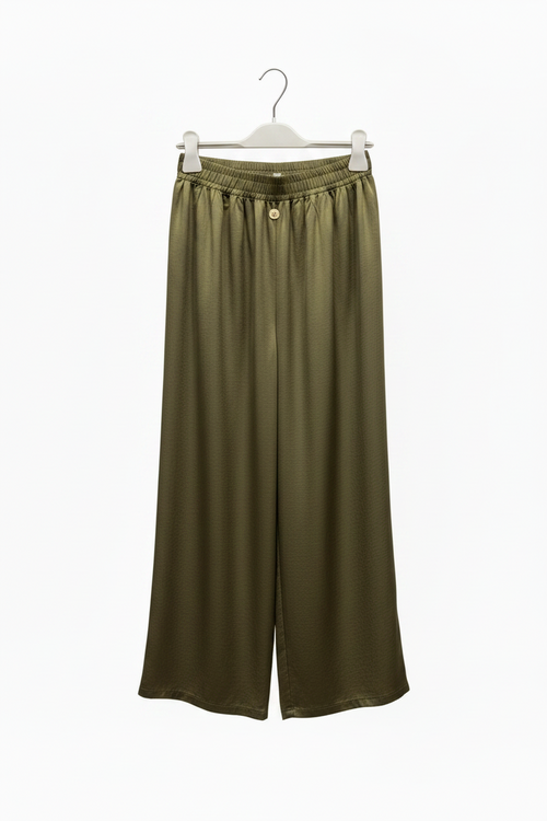 Green wide-leg pants on a hanger against a white background