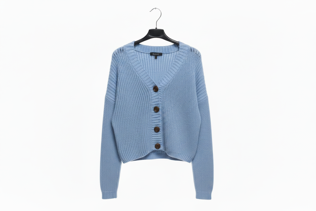 Light blue cardigan on a hanger against a white background