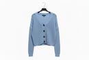 Light blue cardigan on a hanger against a white background
