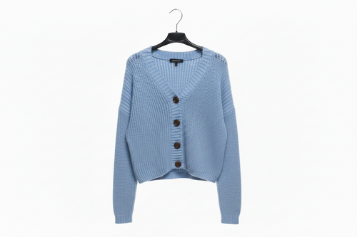 Light blue cardigan on a hanger against a white background