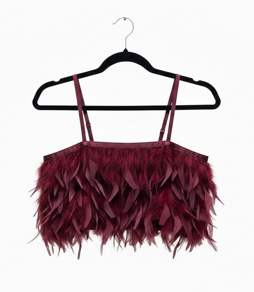 Maroon feathered top on a black hanger against a white background