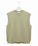 Green sleeveless knitted top on a hanger against a white background