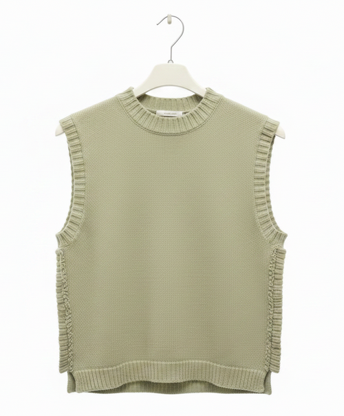 Green sleeveless knitted top on a hanger against a white background