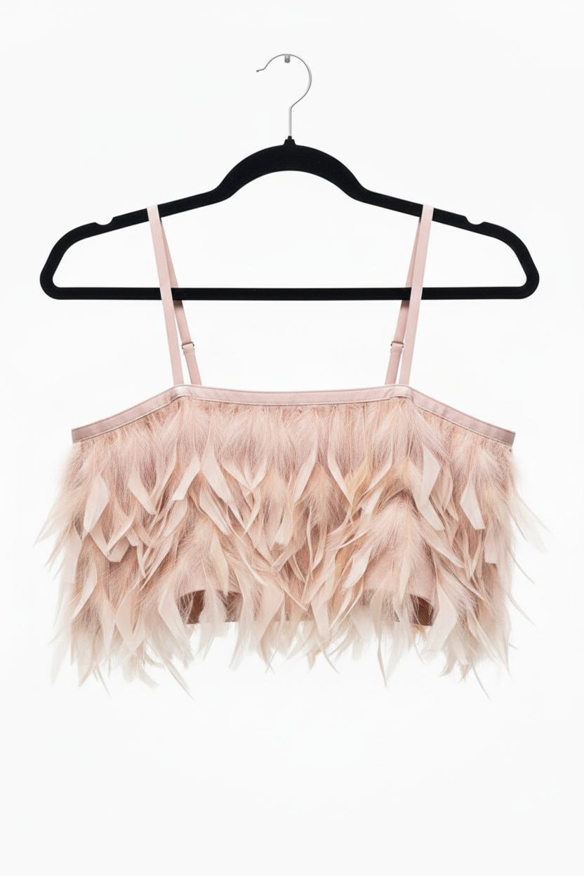 Pink feathered top on a black hanger against a white background