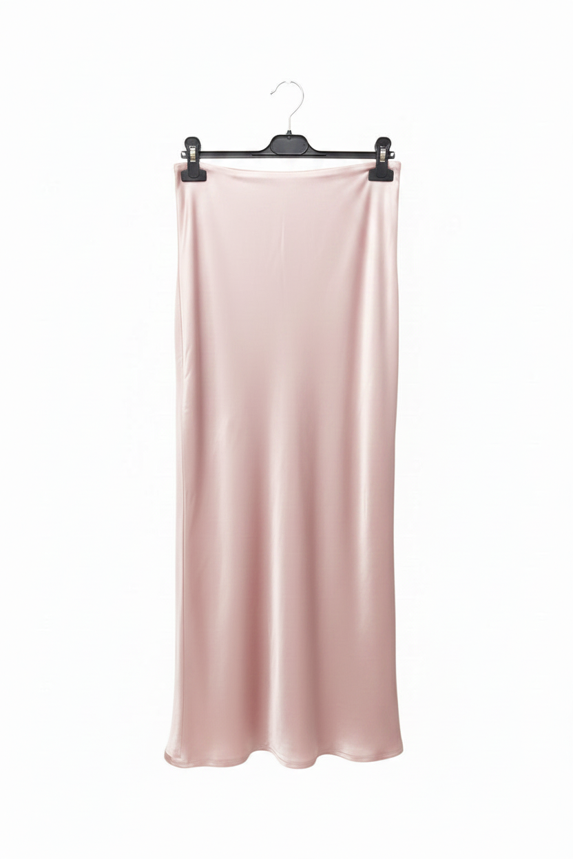 Pink satin skirt hanging on a hanger against a white background