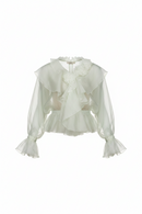 White blouse with ruffled details on a white background