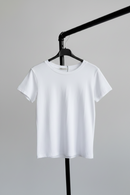 White t-shirt on a hanger against a gray background